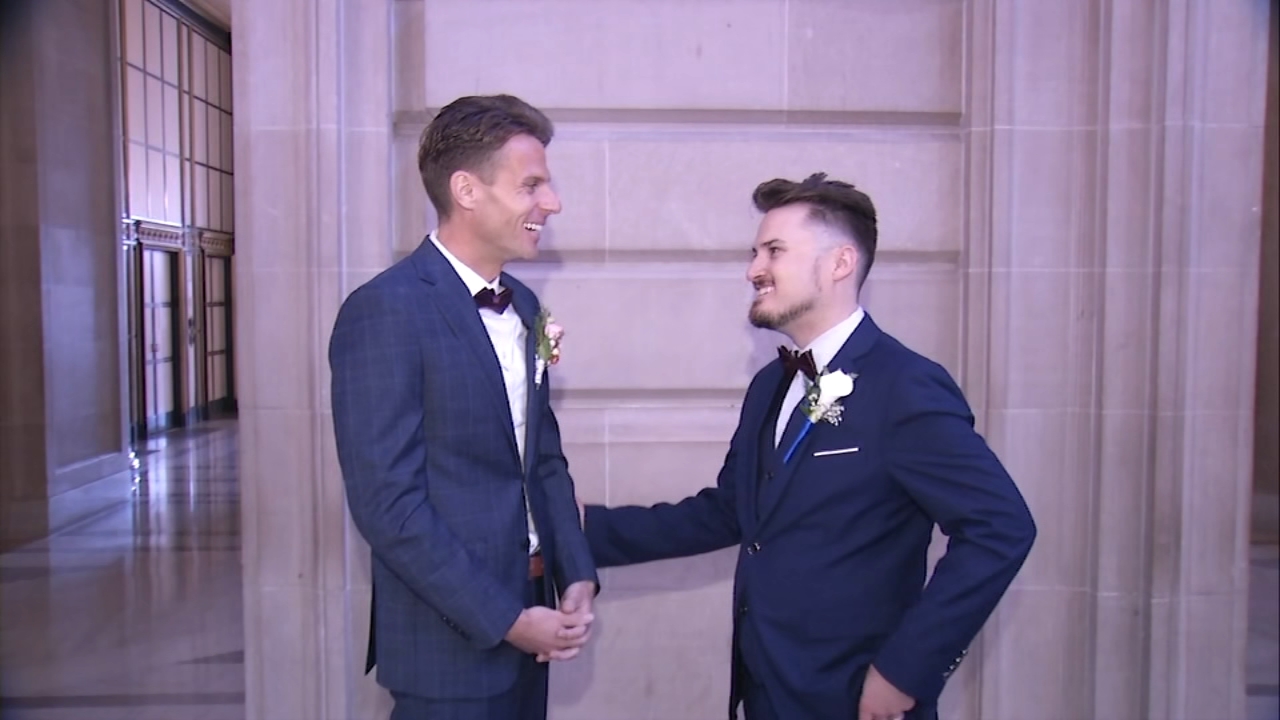 Newlyweds celebrate Pride-themed weddings inside SF City Hall as parade preparations underway